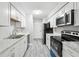Modern kitchen with stainless appliances, updated counter tops, and new flooring at 2930 Parc Lorraine, Lithonia, GA 30038