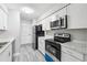 Bright kitchen featuring white cabinets, modern appliances, and marble countertops at 2930 Parc Lorraine, Lithonia, GA 30038