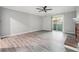 Open living room area with gray-toned hardwood flooring and a brick fireplace at 2930 Parc Lorraine, Lithonia, GA 30038