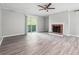 Bright living room with new grey flooring, fireplace, and access to outdoor space at 2930 Parc Lorraine, Lithonia, GA 30038