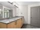 Bathroom featuring double sink vanity with granite countertops and modern fixtures at 390 17Th Nw St # 5008, Atlanta, GA 30363