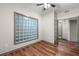 Bright bedroom boasts stylish wood floors, natural light from unique glass block window, and french doors to another room at 390 17Th Nw St # 5008, Atlanta, GA 30363