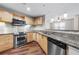 Modern kitchen showcasing granite countertops, stainless steel appliances, and light wood cabinets at 390 17Th Nw St # 5008, Atlanta, GA 30363