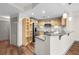 Well-appointed kitchen with stainless steel appliances, granite counters, and bar seating open to living area at 390 17Th Nw St # 5008, Atlanta, GA 30363