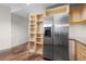 Spacious kitchen with stainless steel refrigerator, open shelving and granite countertops at 390 17Th Nw St # 5008, Atlanta, GA 30363