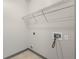Bright laundry room with a wire rack shelf for storage and tiled flooring at 390 17Th Nw St # 5008, Atlanta, GA 30363