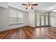 Bright living room with wood floors and ample natural light through French doors leading to the balcony at 390 17Th Nw St # 5008, Atlanta, GA 30363