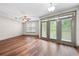 Bright living room with wood floors and ample natural light through French doors leading to the balcony at 390 17Th Nw St # 5008, Atlanta, GA 30363