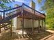 Elevated wooden deck offering outdoor space and providing structural support at 156 Hawthorn Dr, Carrollton, GA 30116