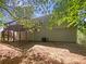 View of the backyard with a wooden deck providing outdoor living space and a connection to nature at 156 Hawthorn Dr, Carrollton, GA 30116