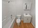 Bathroom featuring wood-look flooring, a shower-tub combo and a neutral vanity at 156 Hawthorn Dr, Carrollton, GA 30116