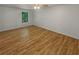 An empty bedroom is brightly lit, with wood-look flooring and a ceiling fan at 156 Hawthorn Dr, Carrollton, GA 30116