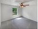 Bedroom with neutral carpeting, a ceiling fan, and a window providing natural light at 156 Hawthorn Dr, Carrollton, GA 30116
