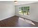 Bedroom showcasing wood-look flooring and a window with natural light and view at 156 Hawthorn Dr, Carrollton, GA 30116