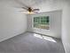 A light-filled bedroom featuring a ceiling fan and neutral carpeting, with a window providing natural light at 156 Hawthorn Dr, Carrollton, GA 30116