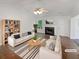 Bright, modern living room with neutral decor, fireplace, and hardwood floors, furnished with stylish sofas and a coffee table at 156 Hawthorn Dr, Carrollton, GA 30116