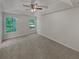 Spacious main bedroom with a vaulted ceiling, featuring a large window, neutral decor, and carpeted floors at 156 Hawthorn Dr, Carrollton, GA 30116