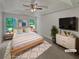 Inviting main bedroom with a vaulted ceiling, featuring a large window, neutral decor, and a comfortable bed at 156 Hawthorn Dr, Carrollton, GA 30116