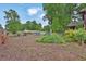 Picturesque backyard with mature trees, garden beds, and serene landscaping at 2272 Plantation Ct, Lawrenceville, GA 30044