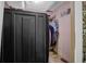Walk-in closet featuring a dark storage unit and carpeted floor with ample hanging space at 2272 Plantation Ct, Lawrenceville, GA 30044
