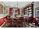 Traditional dining room with decorative wallpaper, wood furniture, and chandelier lighting creating a warm and inviting atmosphere at 2272 Plantation Ct, Lawrenceville, GA 30044