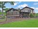 Exterior view of the back of the home, showing a covered patio and well-maintained lawn at 2272 Plantation Ct, Lawrenceville, GA 30044