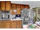 Spacious kitchen with stainless steel refrigerator, and ample wooden cabinetry at 2272 Plantation Ct, Lawrenceville, GA 30044