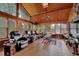 Bright and airy living room with wood ceilings, large windows, leather seating, and tile floors at 2272 Plantation Ct, Lawrenceville, GA 30044