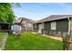 Lush backyard with green grass, wooden fence, and mature trees at 509 Rankin Ne St, Atlanta, GA 30308