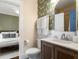 Well-appointed bathroom with a decorative mirror, patterned wallpaper, and stylish fixtures at 509 Rankin Ne St, Atlanta, GA 30308
