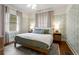 Comfortable bedroom with hardwood floors, wallpaper, and bedside lamps at 509 Rankin Ne St, Atlanta, GA 30308