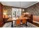 Elegant dining room featuring dark wood floors, wallpaper, and stylish furnishings at 509 Rankin Ne St, Atlanta, GA 30308