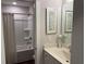 Well-lit bathroom featuring a tub with shower and a vanity with framed mirror at 186 Sunshower Rdg, Canton, GA 30114