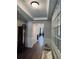 Inviting hallway with wood floors, decorative wainscoting, bench, and view to the living room at 186 Sunshower Rdg, Canton, GA 30114