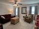 Cozy living room with plush seating, neutral carpet, and modern ceiling fan at 186 Sunshower Rdg, Canton, GA 30114