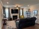 Cozy living room with a fireplace, television, ceiling fan, and natural light from the windows at 186 Sunshower Rdg, Canton, GA 30114