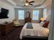 Serene main bedroom with natural light and soft textures, including a television for relaxation at 186 Sunshower Rdg, Canton, GA 30114