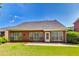 Brick home backyard featuring a patio and lush green lawn at 2119 Wrights Mill Ne Cir, Atlanta, GA 30324