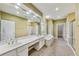 A well-lit bathroom featuring double sinks, a soaking tub, a tile floor, and a glass shower at 2119 Wrights Mill Ne Cir, Atlanta, GA 30324