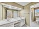 Bathroom with double sinks, large mirror, and tile flooring at 2119 Wrights Mill Ne Cir, Atlanta, GA 30324