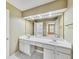 Bathroom featuring double sinks, vanity lighting, and a large mirror at 2119 Wrights Mill Ne Cir, Atlanta, GA 30324