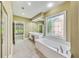 The primary bath includes dual sinks, soaking tub, shower, and a decorative window at 2119 Wrights Mill Ne Cir, Atlanta, GA 30324