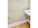 This is a half-bath featuring a pedestal sink, wood floors, and clean lines at 2119 Wrights Mill Ne Cir, Atlanta, GA 30324