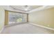 Expansive bedroom with tray ceiling, fan, carpet, and bright window with shutters at 2119 Wrights Mill Ne Cir, Atlanta, GA 30324