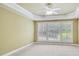 Expansive bedroom with tray ceiling, fan, carpet, and bright window with shutters at 2119 Wrights Mill Ne Cir, Atlanta, GA 30324
