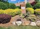 Landscaped entrance to community featuring brick signage and mature plantings at 2119 Wrights Mill Ne Cir, Atlanta, GA 30324