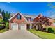 Charming two-story brick home with a well-manicured lawn and a two-car garage at 2119 Wrights Mill Ne Cir, Atlanta, GA 30324