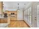 Bright eat-in kitchen featuring wood floors, stainless steel appliances, and sun-filled windows with white shutters at 2119 Wrights Mill Ne Cir, Atlanta, GA 30324