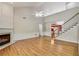 Cozy living area featuring a fireplace, high ceilings, hardwood floors and staircase at 2119 Wrights Mill Ne Cir, Atlanta, GA 30324