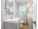 Well-lit bathroom featuring a modern vanity, mirror, and shower with colorful curtain at 248 Upshaw Sw St, Atlanta, GA 30315